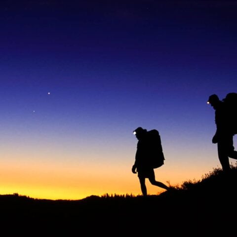 Two hikers at sunrise.